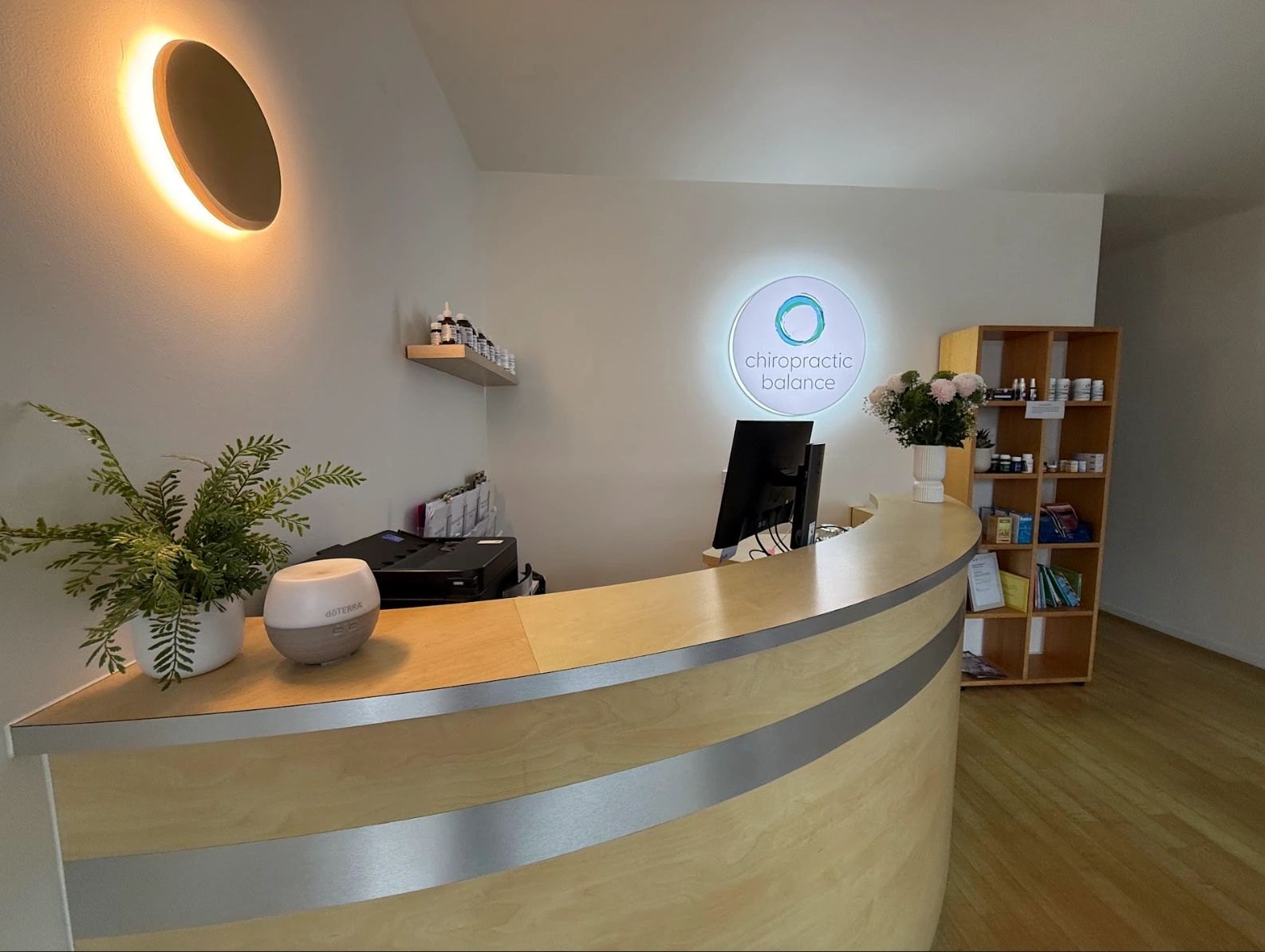 Our curved timber front desk and lit logo